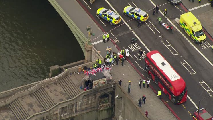 In this image taken from video emergency personnel gather around a body on the southside of Westminster Bridge (ITN via AP)