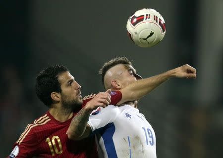Cesc Fabregas of Spain challenges Juraj Kucka of Slovakia (R) during their Euro 2016 qualification soccer match at the MSK stadium in Zilina October 9, 2014. REUTERS/David W Cerny