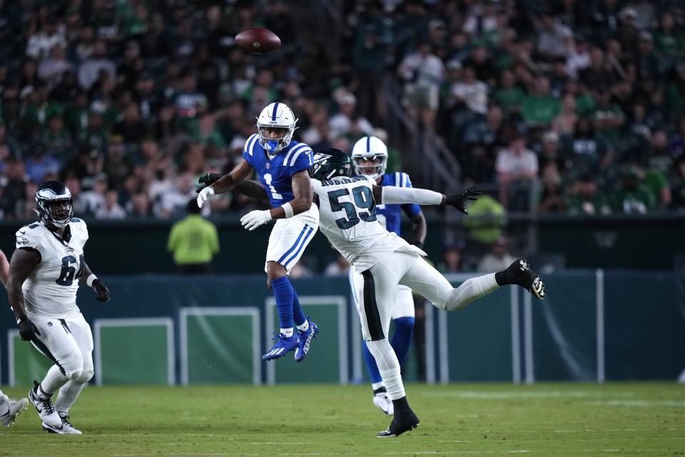 Philadelphia Eagles defensive end Janarius Robinson (59) puts pressure on Indianapolis Colts wide receiver Josh Downs (1) as he looks to catch the ball during the first half of an NFL preseason football game Thursday, Aug. 24, 2023, in Philadelphia. (AP Photo/Matt Slocum)