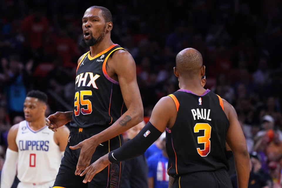 Phoenix Suns forward Kevin Durant (35) celebrates a basket with teammate guard Chris Paul during Game 5 of a first-round NBA basketball playoff series against the Los Angeles Clippers, Tuesday, April 25, 2023, in Phoenix. (AP Photo/Matt York)