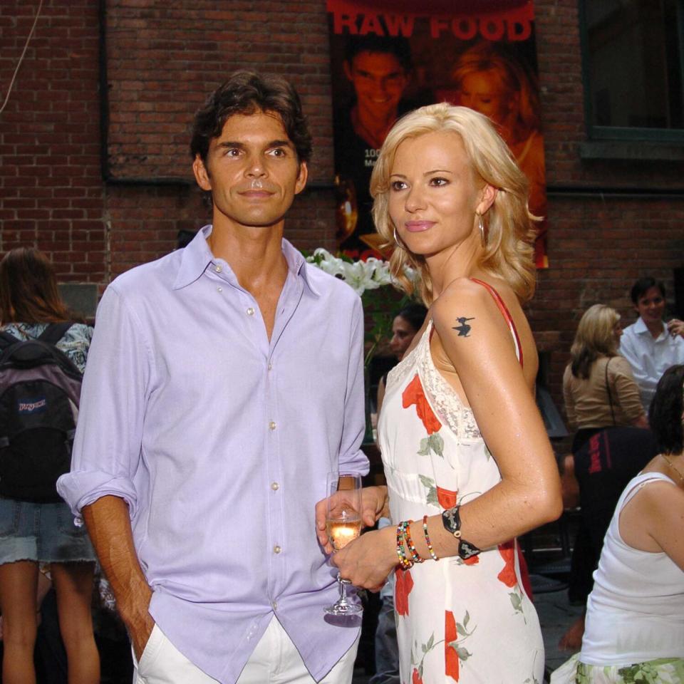 A man wearing a lavender shirt and a woman wearing a floral print dress