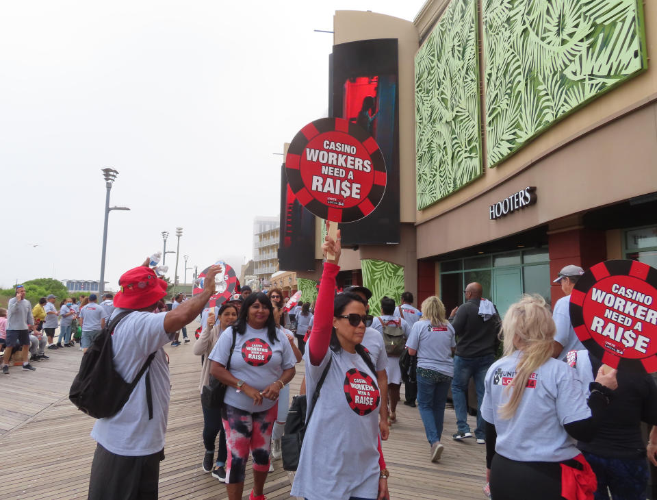 Members of Local 54 of the Unite Here casino workers union picket outside the Tropicana casino in Atlantic City, N.J., on June 1, 2022. On June 24, 2022, the union issued a report estimating that four casinos including the Tropicana could lose $2.6 million a day in the event of a strike, which has been threatened for July 1 if a new contract is not reached by then. (AP Photo/Wayne Parry)