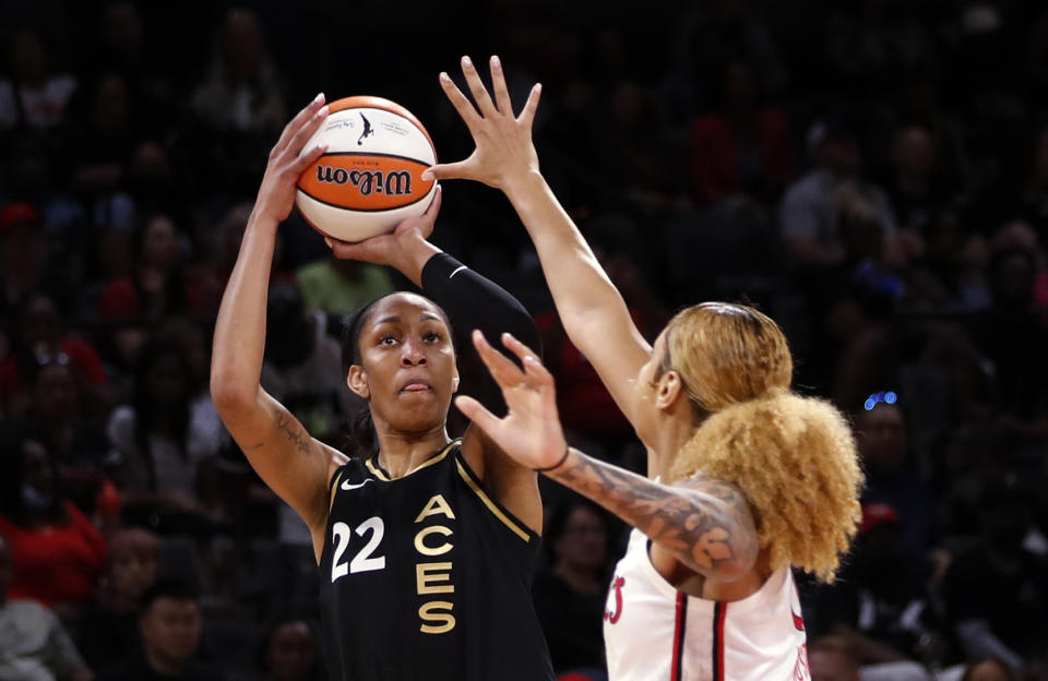 Las Vegas Aces forward A'ja Wilson (22) is guarded by Washington Mystics center Shakira Austin (0) during the first half of a WNBA basketball game Saturday, June 25, 2022, in Las Vegas. (Steve Marcus/Las Vegas Sun via AP)