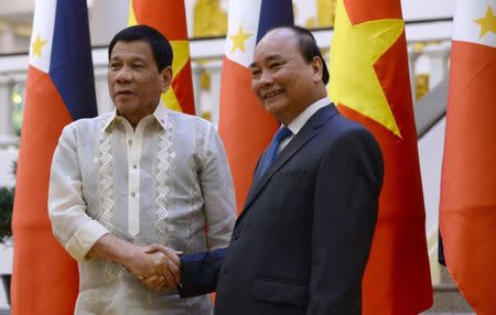 Philippines' President Rodrigo Duterte (L) shakes hands with Vietnamese Prime Minister Nguyen Xuan Phuc as they meet at Phuc's Cabinet Office in Hanoi on September 29, 2016. REUTERS/Hoang Dinh Nam/Pool