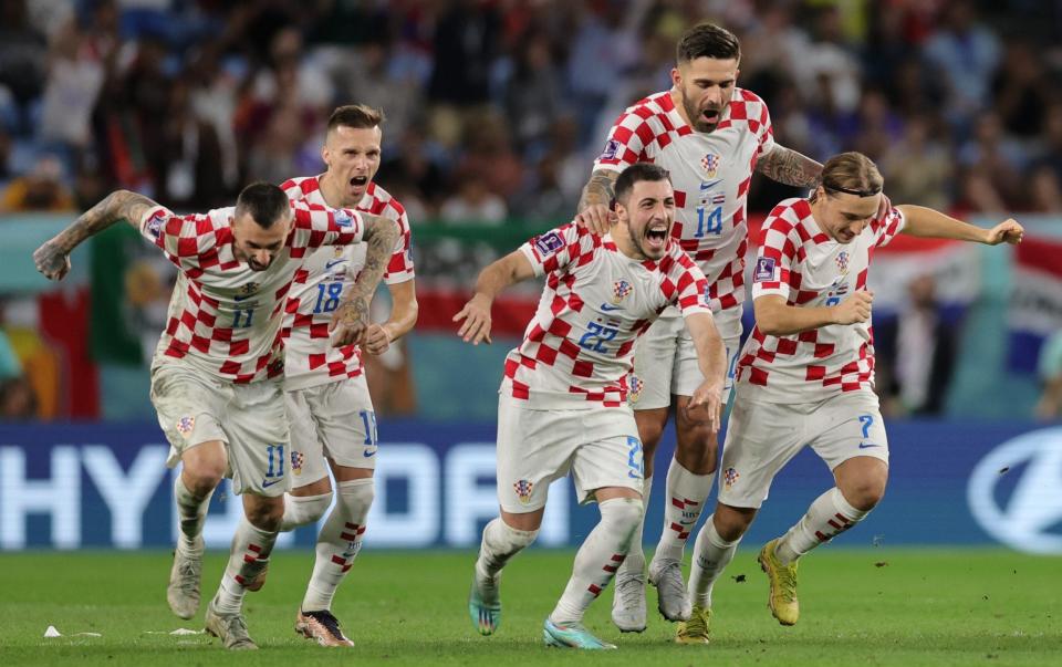 Players of Croatia celebrate after winning the penalty shoot-out of the FIFA World Cup 2022 round of 16 soccer match between Japan and Croatia at Al Janoub Stadium in Al Wakrah, Qatar, - Abir Sultan/Shutterstock