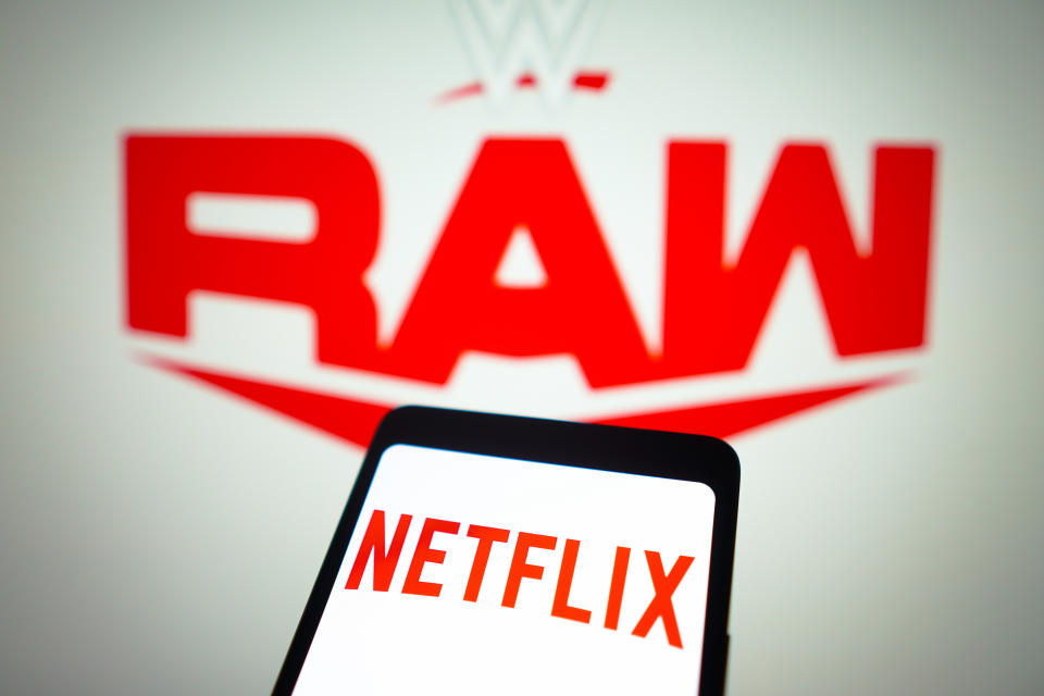 BRAZIL - 2024/01/23: In this photo illustration, the Netflix logo is displayed on a smartphone screen and WWE Raw logo in the background. Starting January 2025, Netflix will exclusively host WWE Raw wrestling in the United States, Canada, the United Kingdom, and Latin America. (Photo Illustration by Rafael Henrique/SOPA Images/LightRocket via Getty Images)