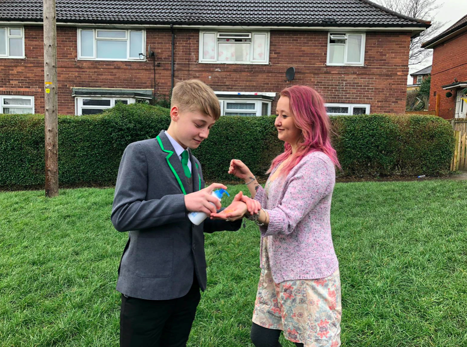 Oliver Cooper, pictured with mum Jenny Tompkins, was reportedly sent home from school for selling hand sanitiser. (SWNS)