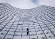 French urban climber Alain Robert, well known as "Spiderman", climbs up the 'Skyper' highrise in Frankfurt, Germany, Saturday, Sept. 28, 2019. (AP Photo/Michael Probst)