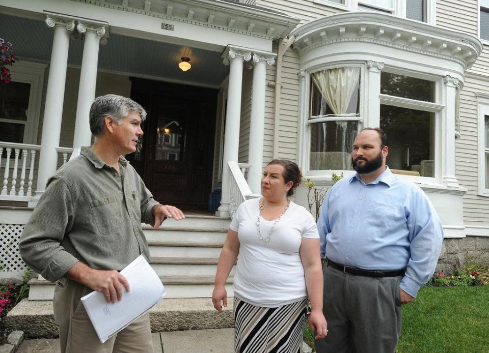 Fall River Preservation Society President Jim Soule talks to Erin Leary and her husband, Jason Caminiti, outside their recently purchased historic home at 544 High St. The Queen Anne-style home, built in 1899, is part of a newly created 40C Historic District.