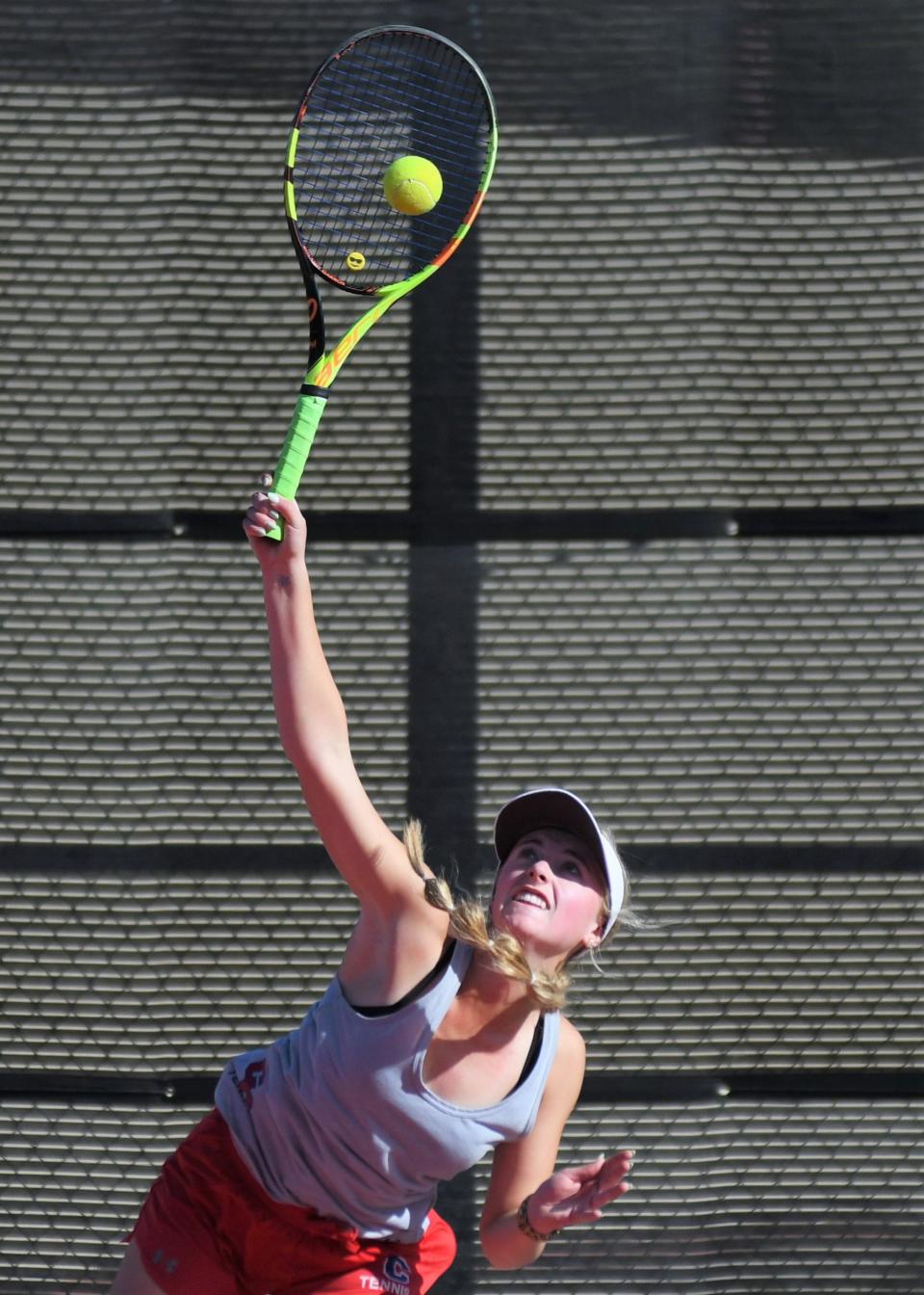 Cooper's Helena Bridge serves the ball in the opening match of the Region I-5A tennis tournament Monday at the McLeod Tennis Center in Lubbock.