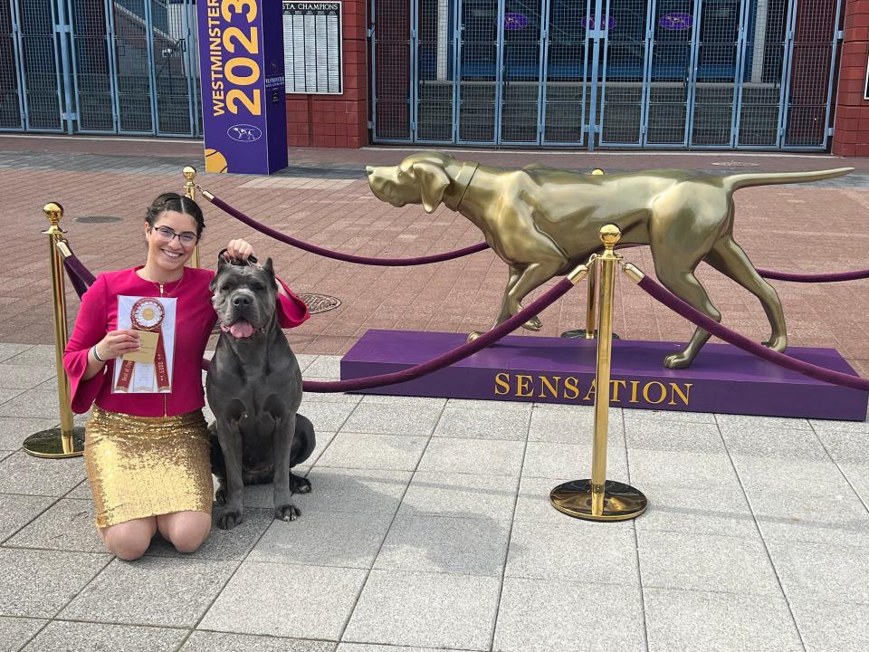 Lihi Ruvio and Sage savor their victory with Sensation the Westminster dog statue.