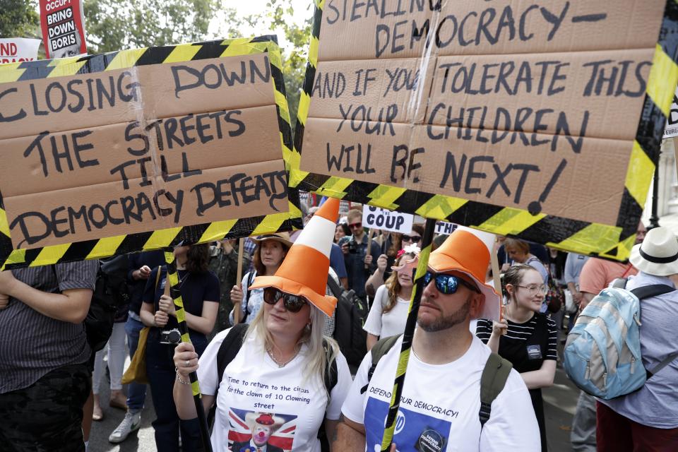 Anti Brexit protesters from 'Stop the Coup' movement demonstrate outside Downing Street in London, Saturday, Aug. 31, 2019. Political opposition to Prime Minister Boris Johnson's move to suspend Parliament is crystalizing, with protests around Britain and a petition to block the move gaining more than 1 million signatures. (AP Photo/Alastair Grant)