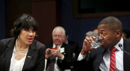 Flint, Michigan Mayor Karen Weaver (L) talks with Flint School District Superintendent Bilal Kareem Tawwab (R) before testifying at the House Democratic Steering and Policy Committee on the Flint lead water crisis in Washington February 10, 2016. REUTERS/Gary Cameron