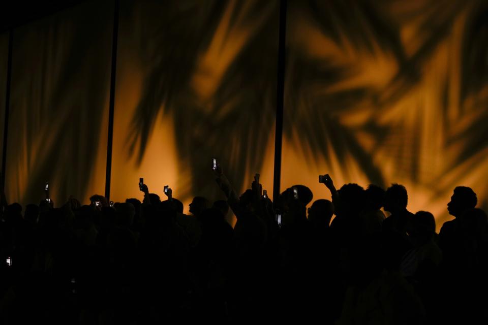 Guests attend the Giorgio Armani Men's Spring Summer 2025 fashion show, that was presented in Milan, Italy, Monday, June 17, 2024. (AP Photo/Luca Bruno).