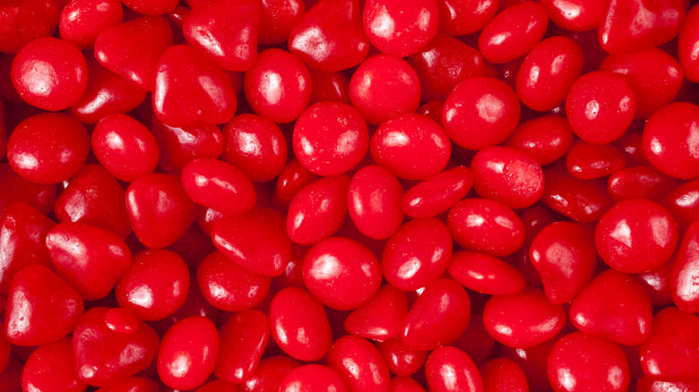 Handfuls of Red Hot candies 