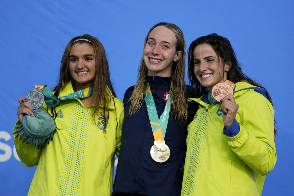 From left, Brazil's Maria Da Silva, Paige Madden of the United States, and Brazil's Gabrielle Goncalves, celebrate with their medal at the podium for the women's 400-meters freestyle at the Pan American Games in Santiago, Chile, Saturday, Oct. 21, 2023. (AP Photo/Fernando Vergara)