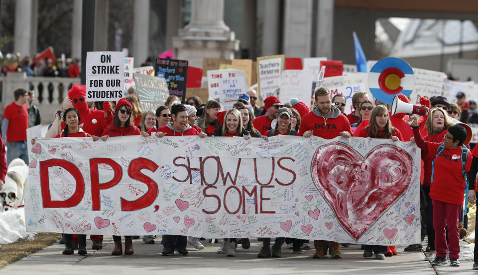 Instructors march to Denver Public Schools headquarters to deliver Valentine Day cards Wednesday, Feb. 13, 2019, in Denver. Teachers walked off their jobs Monday, the first strike by teachers in Denver in 25 years. (AP Photo/David Zalubowski)