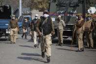 Indian police chase activists of Peoples Democratic party (PDP) protesting against India's new land laws that allows any Indian citizen to buy land in the disputed region in Srinagar, Indian controlled Kashmir, Thursday, Oct. 29, 2020. Until last year, Indians were not allowed to buy property in the region. But in August 2019, Prime Minister Narendra Modi’s government scrapped the disputed region’s special status, annulled its separate constitution, split the region into two federal territories. (AP Photo/Mukhtar Khan)