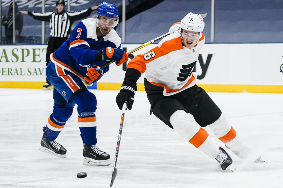 Philadelphia Flyers' Travis Sanheim (6) fights for control of the puck with New York Islanders' Jordan Eberle (7) during the second period of an NHL hockey game Thursday, April 8, 2021, in Uniondale, N.Y. (AP Photo/Frank Franklin II)