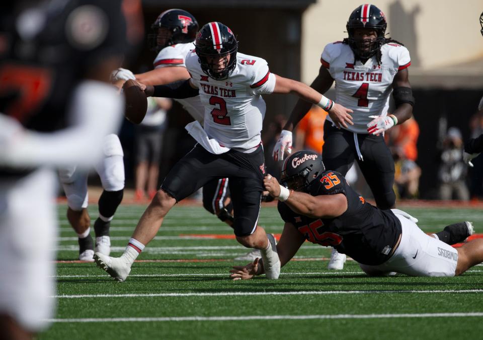 Texas Tech quarterback Behren Morton tries to escape pressure during the Red Raiders' 41-31 loss to Oklahoma State on Saturday in Stillwater, Oklahoma. Morton got his first college start in the game, throwing for 379 yards and two touchdowns, as well as running for a TD.