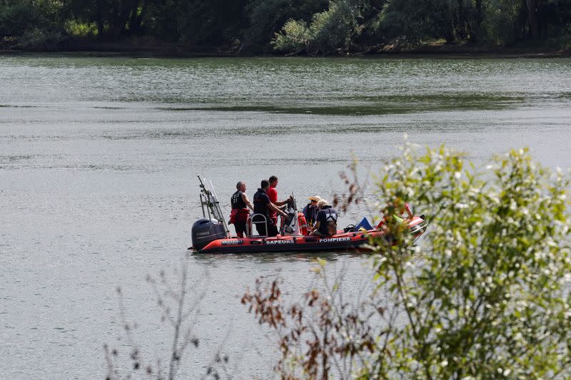 Rescue divers from the firefighter department patrol in search for lost Beluga whale, in Les Andelys