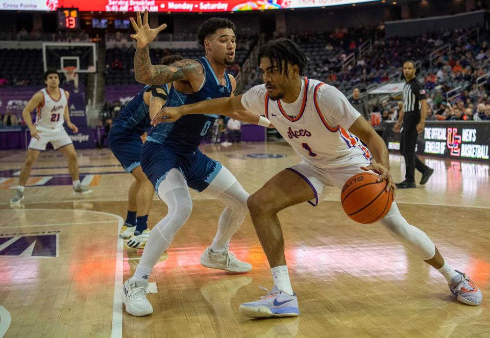 Evansville’s Antoine Smith Jr. (1) drives against Illinois Chicago's Jace Carter (0) as the University of Evansville Purple Aces play the University of Illinois at Chicago Flames at Ford Center in Evansville, Ind., Wednesday, Feb. 22, 2023. 