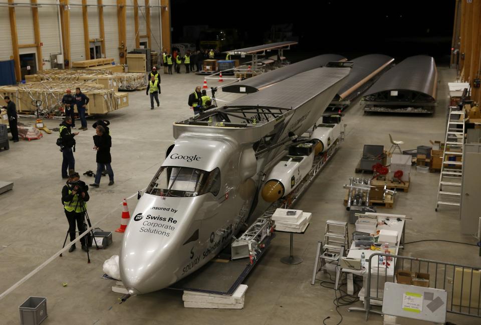The dismantled Solar Impulse 2 aircraft is pictured before being loaded into a Cargolux Boeing 747 cargo aircraft at Payerne airport January 5, 2015. The Solar Impulse 2 aircraft and its team relocates to Abu Dhabi from where an attempt to fly around the world in stages using only solar energy will be made from March 2015. The aircraft, weighing 2.4 tons with a wingspan of 72 meters, is fitted with more than 17,000 solar cells. REUTERS/Denis Balibouse (SWITZERLAND - Tags: TRANSPORT ENVIRONMENT SCIENCE TECHNOLOGY)