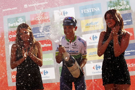 Orica GreenEdge rider Esteban Chaves of Colombia sprays champagne as he celebrates on the podium after winning the 158.7 km (98.6 miles) 2nd stage of the Vuelta Tour of Spain cycling race from Alhaurin de la Torre to Caminito del Rey, in Ardales, southern Spain, August 23, 2015. REUTERS/Jon Nazca