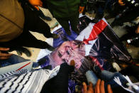 <p>Palestinian demonstrators step on a poster depicting U.S. President Donald Trump during a protest in the West Bank city of Hebron, Feb. 24, 2017. (Photo: Mussa Qawasma/Reuters) </p>