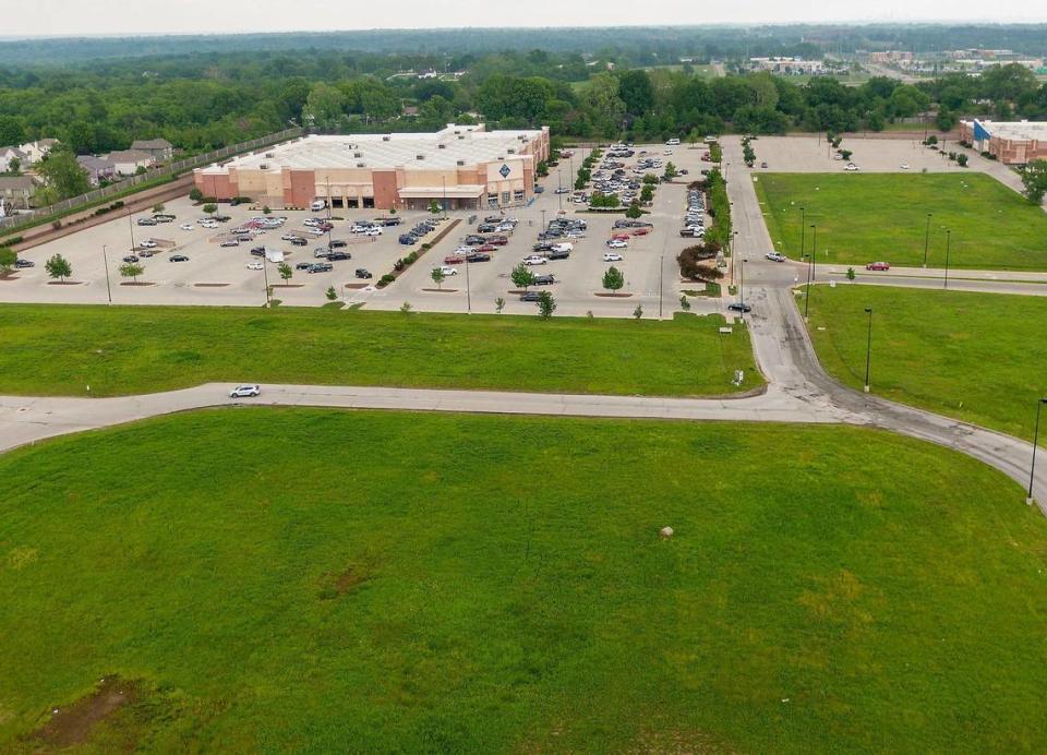 Parcels of vacant land for sale sit near the Sam’s Club on Parallel Parkway, within the Plaza at the Speedway shopping center, on Tuesday, May 14, 2024, in Kansas City, Kansas. The parcels are classified as hay farms because of a vague Kansas law and it is allowing owners to save on property taxes.