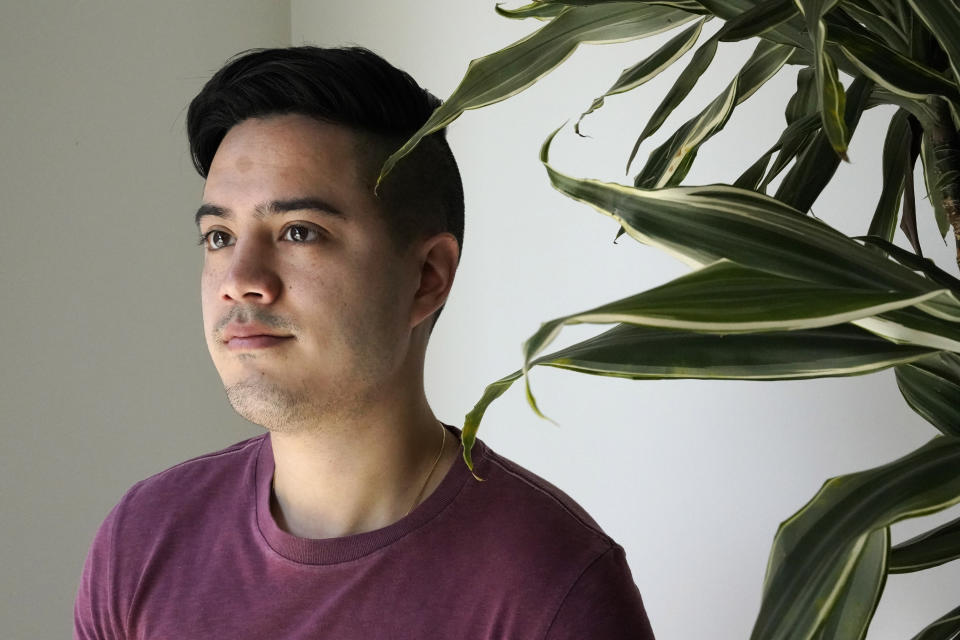 Benjamin Beltran, 26, poses for a portrait, Tuesday Aug. 18, 2020, in Washington. For most of his childhood, Beltran identified with his dad’s roots as a Filipino growing up. At times, that made his white mother worry he was forgetting her ancestry, which traces to Scotland and Ireland. (AP Photo/Jacquelyn Martin)