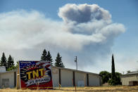 <p>A plume rises behind a building in Esparto, Calif., as a wildfire burns on July 1, 2018.(Photo: Noah Berger/AP) </p>