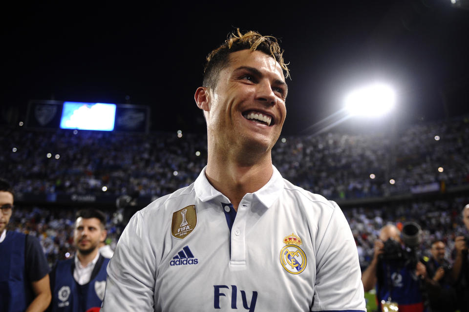 FILE - In this Sunday, May 21, 2017 file photo, Real Madrid's Cristiano Ronaldo celebrates after winning the Spanish La Liga title at the end of the soccer match between Malaga and Real Madrid in Malaga, Spain. Ronaldo, who joined Juventus for this season from Real Madrid, became the first player to win the English Premier League (with Manchester United), the Spanish league (with Madrid) and Serie A. (AP Photo/Daniel Tejedor, File)