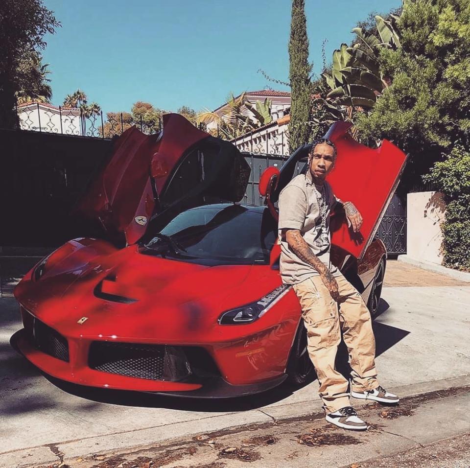 <img src="tyga-ferrari.jpg" alt="Rapper Tyga poses in front of one of a leased Ferrari">