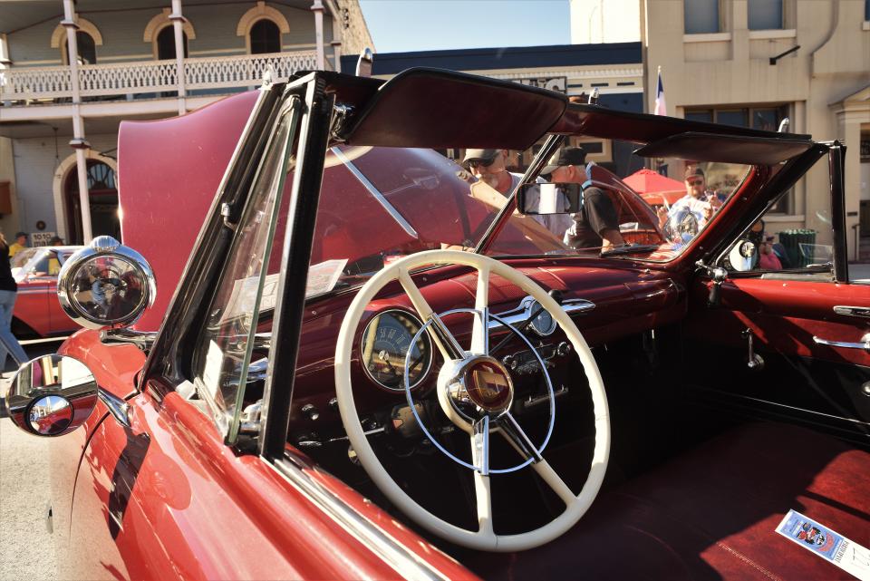 The interior of a 1950 Ford convertible had a prominent steering wheel.