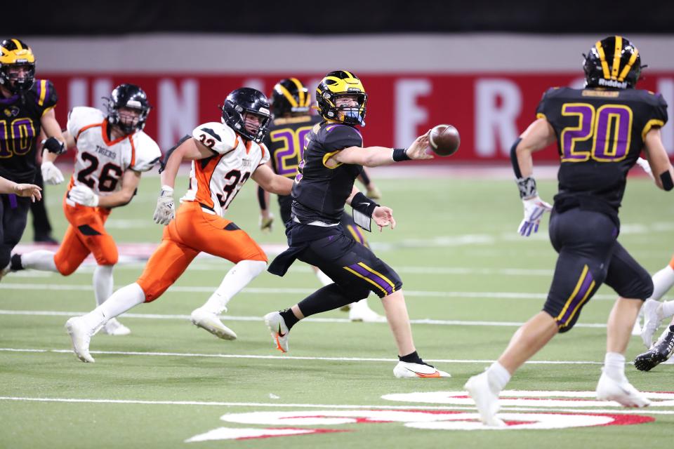 Herreid/Selby Area QB Trey Hettick (5) pitches the ball to RB Brenden Begeman (20) during the 9A State Championship game against the Howard Tigers;  Howard won 55-18.