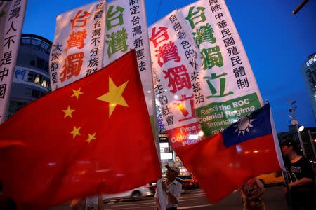 Members of a Taiwanese independence group march with flags around the group of pro-China supporters holding a rally calling peaceful reunification, in Taipei, Taiwan in this file photo dated May 14, 2016. REUTERS/Tyrone Siu