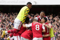 Arsenal players celebrate after their teammate Granit Xhaka scored his side's third goal during the English Premier League soccer match between Arsenal and Tottenham Hotspur, at Emirates Stadium, in London, England, Saturday, Oct. 1, 2022. (AP Photo/Kirsty Wigglesworth)