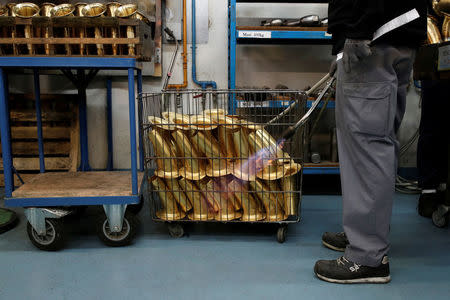 A worker forms the bells of saxophones at the Henri Selmer wind instruments factory in Mantes-la-Ville near Paris, France, January 17, 2018. REUTERS/Benoit Tessier