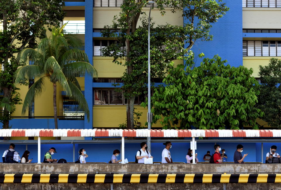 People wait to board a bus back to Malaysia as the Vaccinated Travel Lane between Singapore and Malaysia opens after the land border between the two countries reopened following nearly two years of being shut down due to the coronavirus disease (COVID-19) pandemic, at a bus station in Singapore November 29, 2021. REUTERS/Caroline Chia