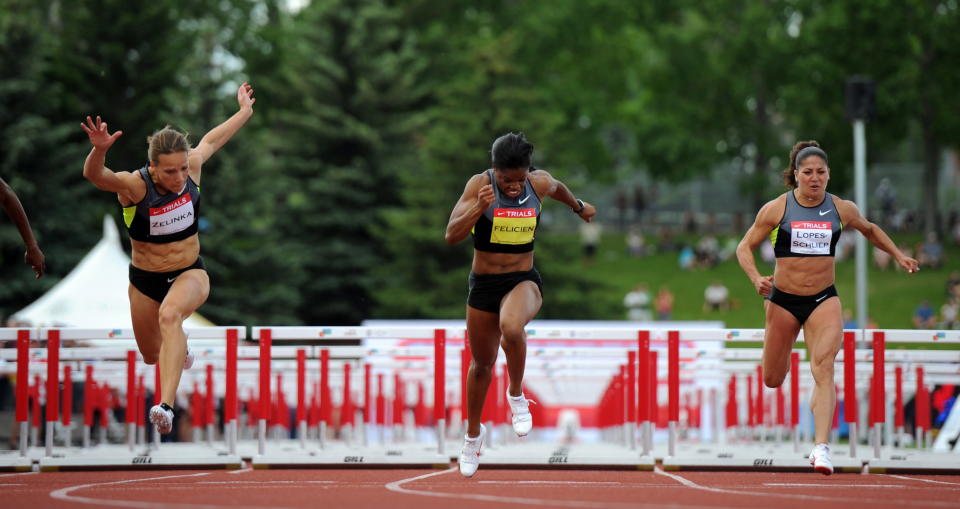 Heptathlete Jessica Zelinka, left, wins the women's 100-metre hurdles championship as she races against Perdita Felicien, middle, and Priscilla Lopes-Schliep at the Canadian Track and Field Championships in Calgary, Alta., Saturday, June 30, 2012.THE CANADIAN PRESS/Sean Kilpatrick