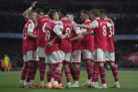 Arsenal's Martin Odegaard, second right, celebrates with Arsenal's Oleksandr Zinchenko after scoring his side's opening goal during the English Premier League soccer match between Arsenal and Chelsea at the Emirates Stadium in London, Tuesday, May 2, 2023. (AP Photo/Kin Cheung)