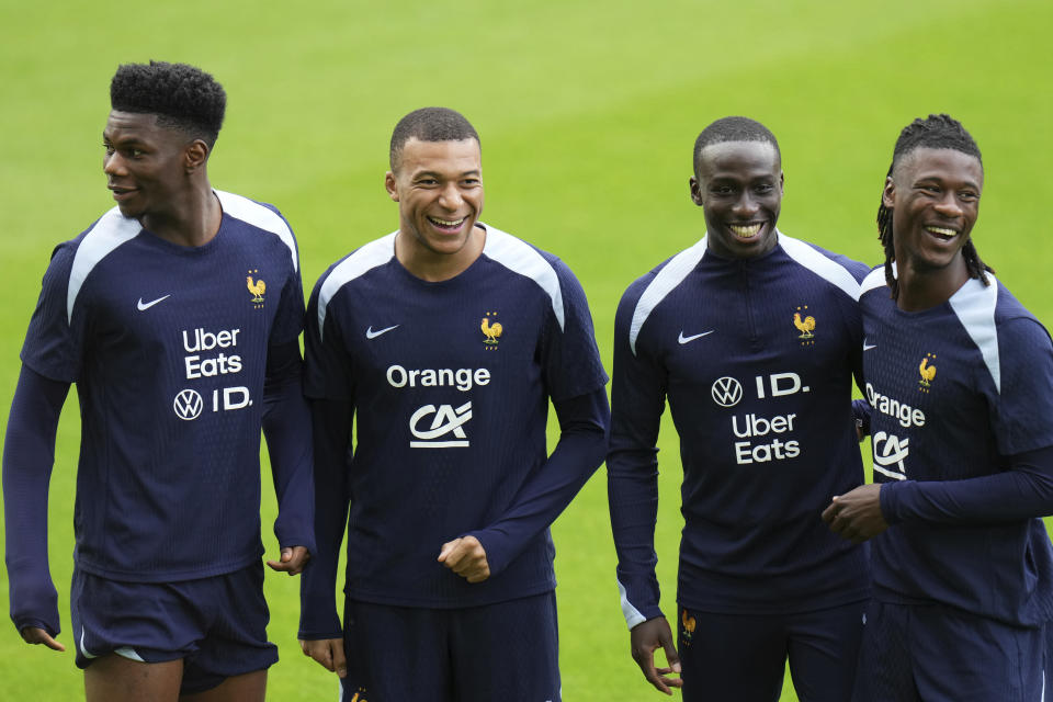 France's Aurelien Tchouameni, left, France's Kylian Mbappe, second left, France's Ferland Mendy, second right, and France's Eduardo Camavinga gesture during a training session in Paderborn, Germany, Saturday, June 15, 2024. France will play against Austria during their Group D soccer match at the Euro 2024 soccer tournament on June 17. (AP Photo/Hassan Ammar)