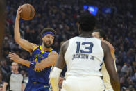 Golden State Warriors guard Klay Thompson (11) looks to pass the ball in front of Memphis Grizzlies forward Jaren Jackson Jr. (13) during the first half of Game 6 of an NBA basketball Western Conference playoff semifinal in San Francisco, Friday, May 13, 2022. (AP Photo/Tony Avelar)