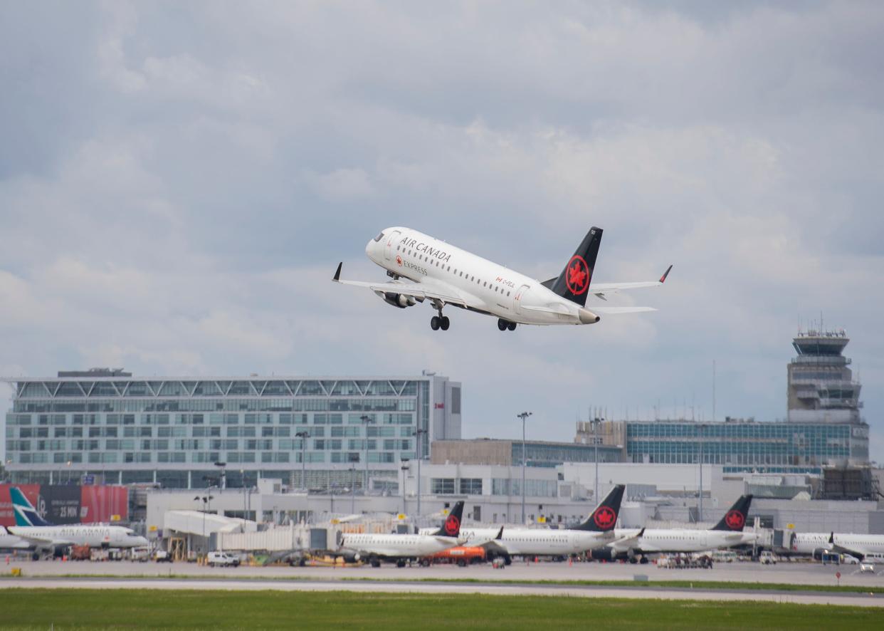 An Air Canada jet takes off from Trudeau Airport in Montreal on Thursday. Air Canada is cutting more than 15% of its scheduled flights in July and August as airports face lengthy delays and cancellations amid an overwhelming travel resurgence.