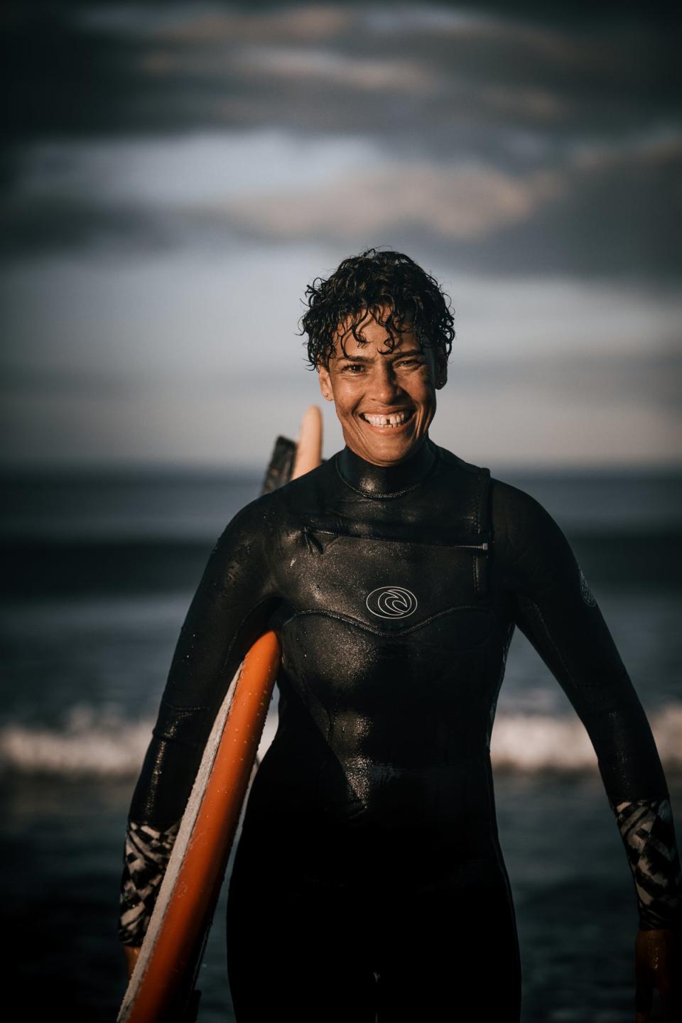 Paula George, now a keen surfer, pictured in New Zealand. (Jo Caird)