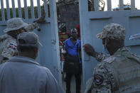 Dominican Republic soldiers close a border gate on a Haitian man who was hoping to cross into Dajabon, Dominican Republic, Friday, Nov. 19, 2021. As the rest of the world closes its doors to Haitian migrants, the country that shares an island with Haiti also is cracking down in a way that human rights activists say hasn’t been seen in decades. (AP Photo/Matias Delacroix)