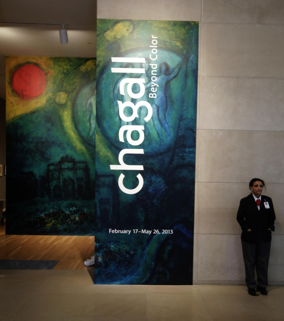 In this photo taken Wednesday, Feb. 13, 2013, a guard stands at the entrance of the "Chagall: Beyond Color," exhibit during a preview at the Dallas Museum of Art in Dallas. This will be the only U.S. venue to host the exhibit that opens to the public on Sunday. (AP Photo/LM Otero)