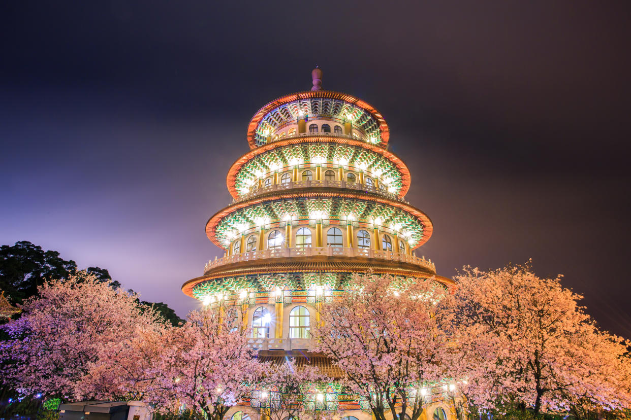 Wuji Tianyuan Temple in Taipei, Taiwan with sakura trees at night. (Photo: Gettyimages)