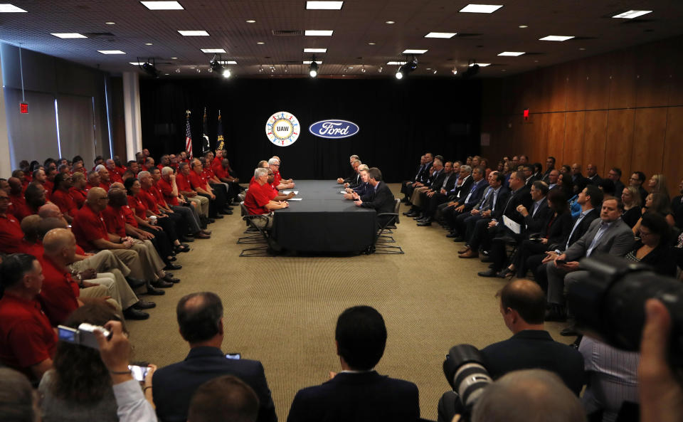 Negotiators from the United Auto Workers, left, and Ford Motor Co., meet as they open their contract talks Monday, July 15, 2019, in Dearborn, Mich. (AP Photo/Carlos Osorio)